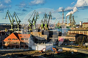 View of the shipyard and port - industry part of the city of Gdansk GdaÅ â€žsk with shipyard constructions and cranes. Poland